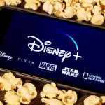Disney Plus on smartphone with popcorn.