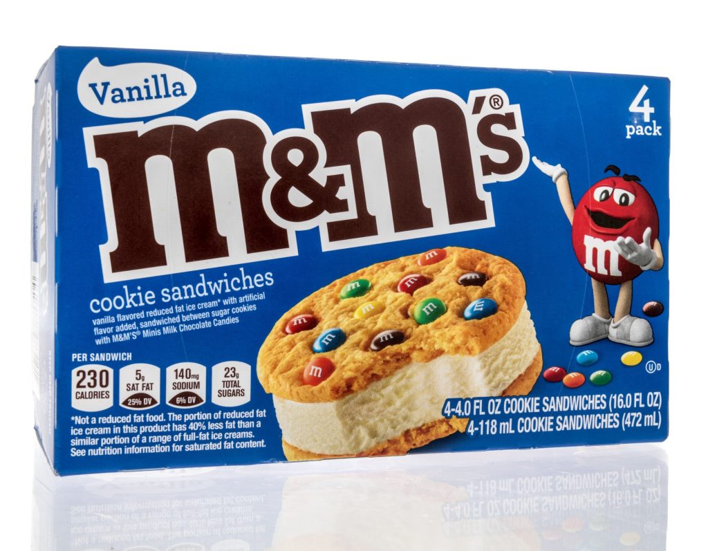 A package of MMs frozen ice cream cookie sandwiches on an isolated background