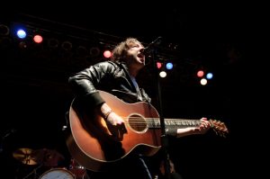 Tom Higgenson of the Plain White Ts sings and play guitar on stage