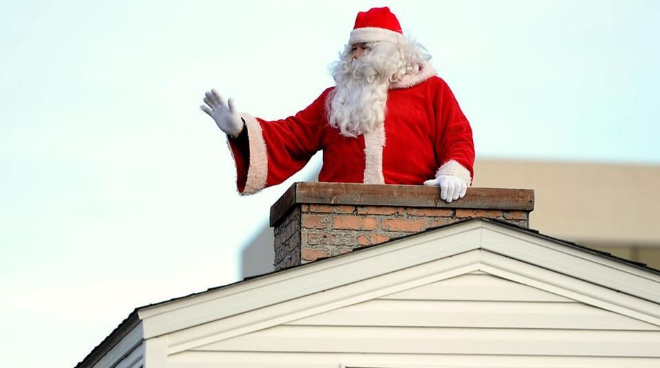 Santa in a chimney on a Christmas parade float