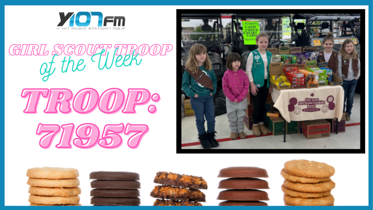 Girl Scout troop standing next to their cookie booth in a home improvement store